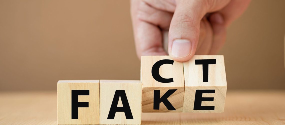 Hand,Flipping,Wooden,Cubes,For,Change,Wording,From,"fake",To