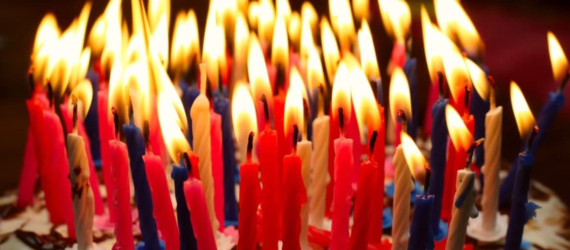 birthday cake with the lot of burning candles
