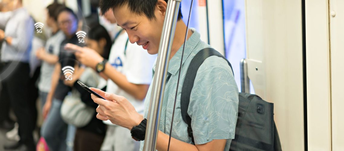 Happy,Man,Is,Traveler,Using,Smartphone,With,5g,Connection,At